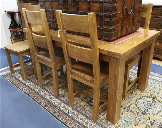An oak dining table and six woodseat chairs W.150cm